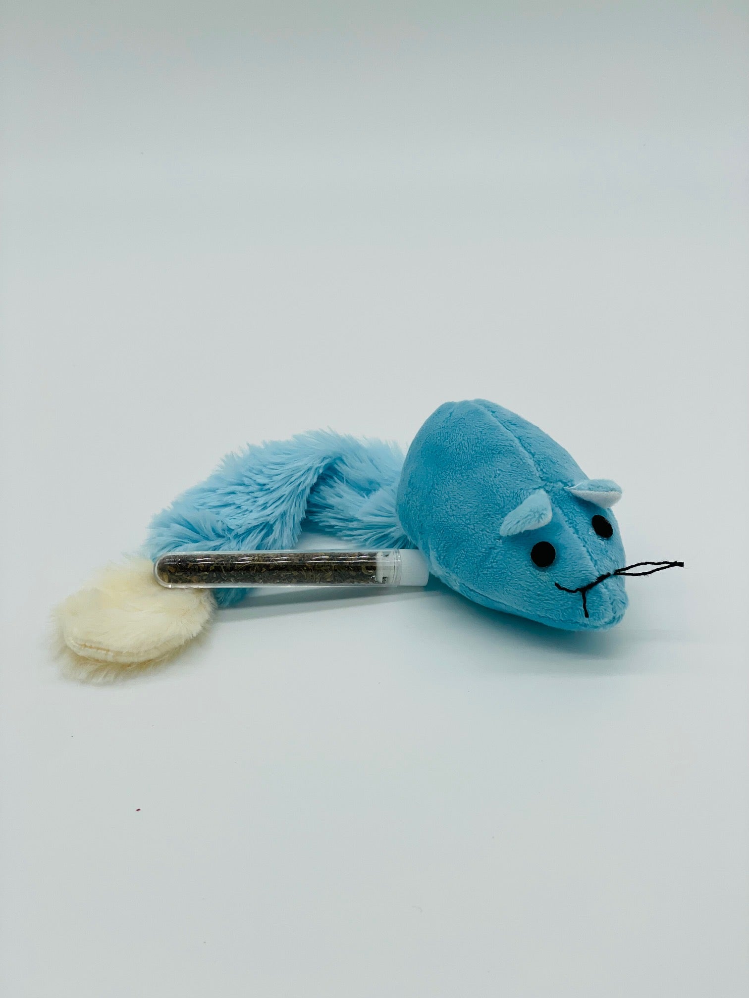 Blue plush toy resembling a cat with a white base on a light gray background