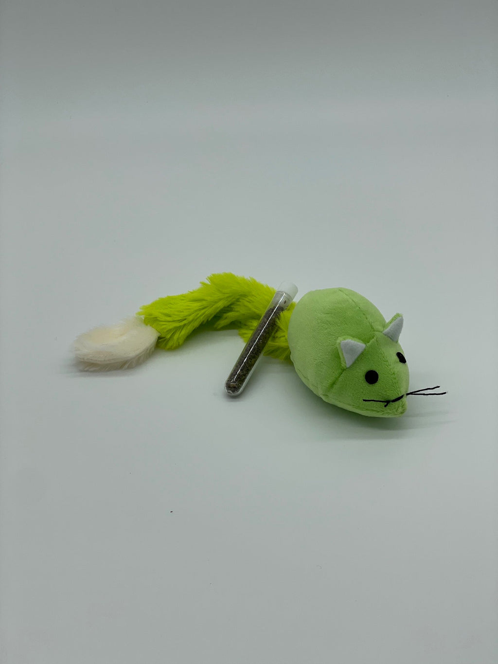 Green plush toy with a keychain on a white background cat toy