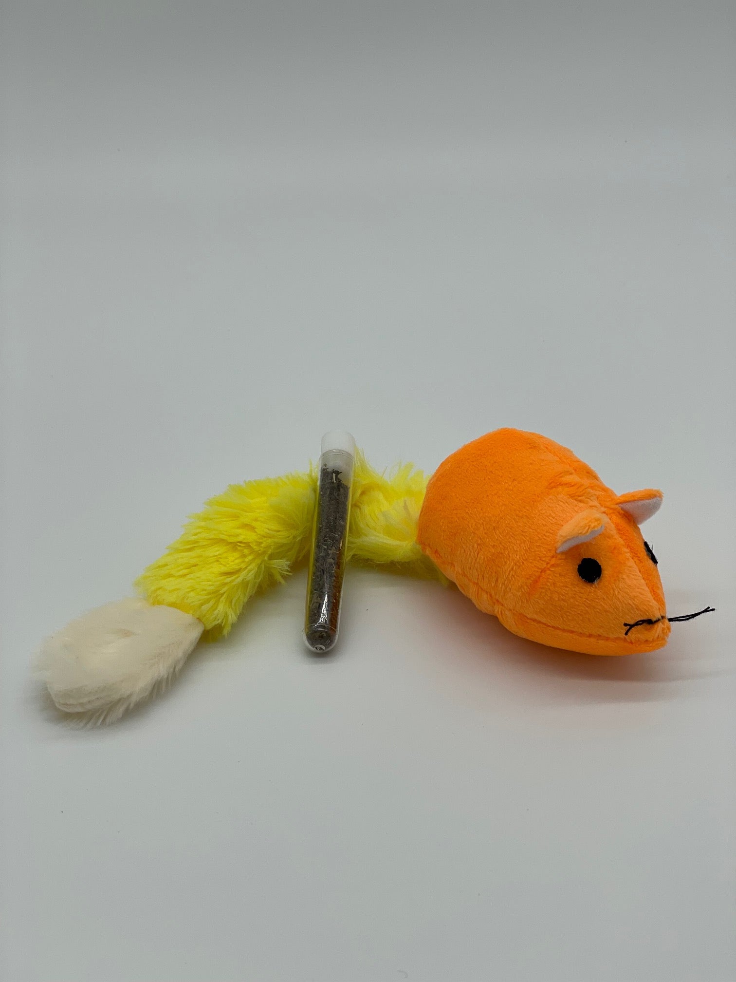 Plush toy mouse with a yellow tail on a white background