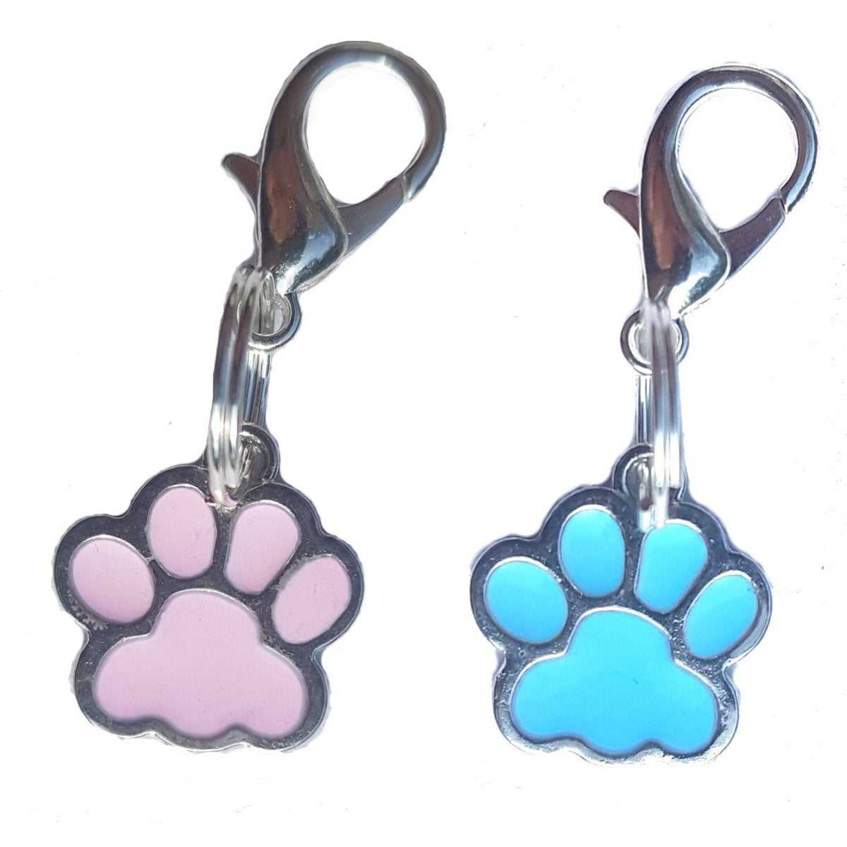 Two paw-shaped tags, one pink and one blue, with metal clasps on a white background.